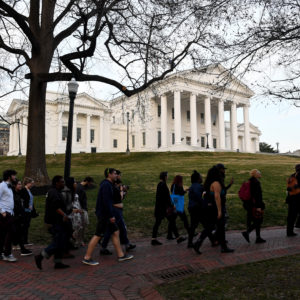 RICHMOND, VA - FEBRUARY 7:Protesters walk in front of the Virginia State Capitol February 07, 2019 in Richmond, VA. The top three Democrats in the Virginia legislature, Virginia’s Gov. Ralph Northam, Lt. Gov. Justin Fairfax and Attorney General Mark R. Herring are plagued by scandals and facing calls to resign. (Photo by Katherine Frey/The Washington Post)