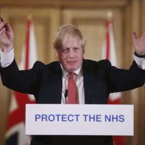 FILE - In this Sunday March 22, 2020 file photo British Prime Minister Boris Johnson gestures during his daily COVID 19 coronavirus press briefing to announce new measures to limit the spread of the virus, at Downing Street in London.  The British prime minister’s office says Boris Johnson will return to work Monday April 27, 2020, two weeks after he was discharged from a London hospital where he was treated for the new coronavirus. (Ian Vogler / Pool via AP, File)