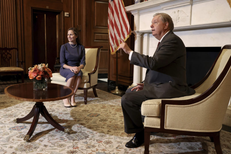 WASHINGTON, DC - SEPTEMBER 29: Seventh U.S. Circuit Court Judge Amy Coney Barrett, President Donald Trump's nominee for the U.S. Supreme Court, listens as Senate Judiciary Committee Chairman Lindsey Graham (R-SC) answers reporters' questions before a meeting in the Mansfield Room at the U.S. Capitol September 29, 2020 in Washington, DC. Barrett is meeting with senators ahead of her confirmation hearing which is scheduled to begin on October 12, less than a month before Election Day. (Photo by Chip Somodevilla/Getty Images)