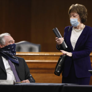 Sen. Tim Kaine, D-Va., speaks with Sen. Susan Collins, R-Maine, before a Senate Health Education Labor and Pensions Committee hearing on new coronavirus tests on Capitol Hill in Washington, Thursday, May 7, 2020. (AP Photo/Andrew Harnik, Pool)