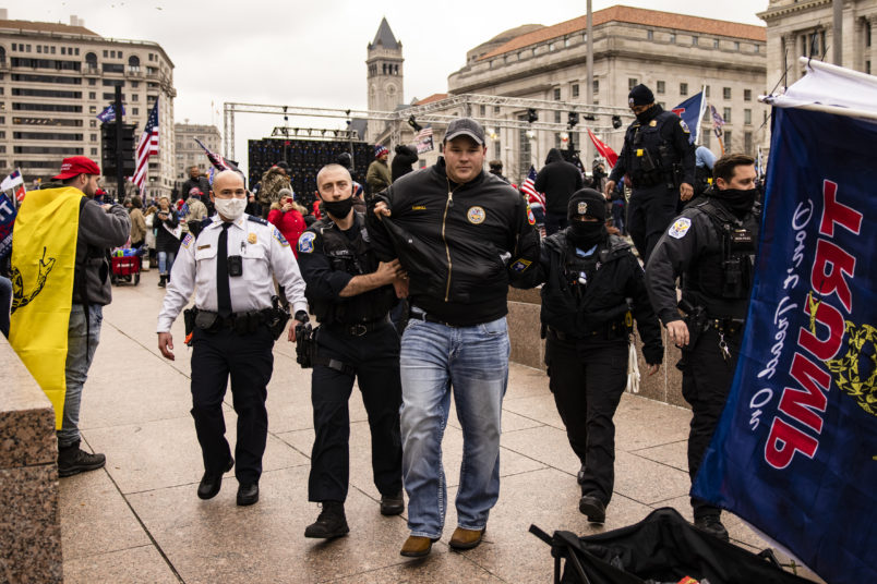 WASHINGTON, DC - JANUARY 05: US Park Police officers arrest a man on gun charges after officers spotted him carrying a concealed firearm during a pro-Trump rally at Freedom Plaza on January 5, 2021 in Washington, DC. Today's rally kicks off two days of pro-Trump events fueled by President Trump's continued claims of election fraud and a last ditch effort to overturn the results before Congress finalizes them on January 6. Gun laws in the District are extremely tight and further restrictions have been put in place within 100ft fo First Amendment events. (Photo by Samuel Corum/Getty Images)