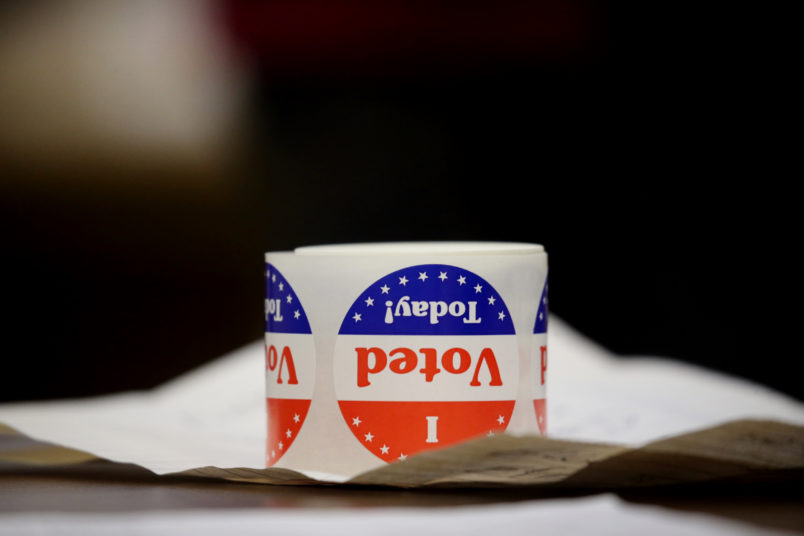 QUINCY - NOVEMBER 3: Stickers sit on a table at Saint John the Baptist Parish in Quincy, MA on election day, November 03, 2020. Massachusetts voters headed to the polls amid a pandemic and political maelstrom. (Photo by Craig F. Walker/The Boston Globe via Getty Images)