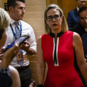 WASHINGTON, DC - JUNE 08: U.S. Sen. Kirsten Sinema (D-AZ) heads back to a bipartisan meeting on infrastructure in the basement of the U.S. Capitol building after the original talks fell through with the White House on June 8, 2021 in Washington, DC. Senate Majority Leader Chuck Schumer (D-NY) said they are now pursuing a two-path proposal that includes a new set of negotiations with a bipartisan group of senators. (Photo by Samuel Corum/Getty Images) *** Local Caption *** Kirsten Sinema