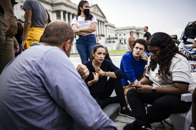 WASHINGTON, DC - [DATE]: U.S. Representatives Alexandria Ocasio-Cortez (D-NY) (center) and Cori Bush (D-MO) (right) continue their protest for an extension of the eviction moratorium on the steps to the House of Representatives at the U.S. Capitol Building on August 1, 2021 in Washington, DC. The eviction moratorium put into place during the coronavirus pandemic expired on Saturday which raised the risk that many facing hardship from the pandemic would lose their homes. (Photo by Samuel Corum/Getty Images)